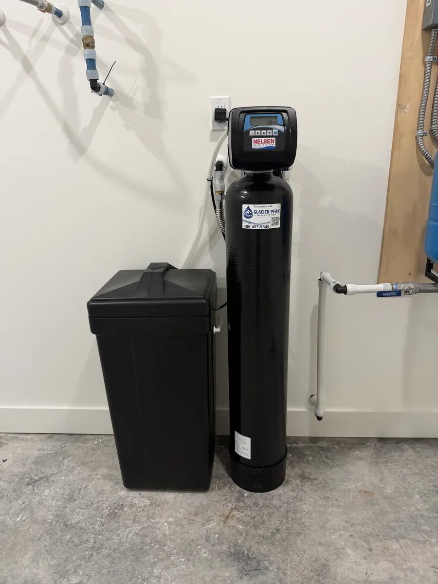 Black water treatment tank and brine cabinet installed in a utility room
